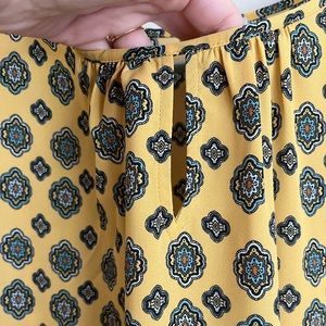 Such a cute top ! Size small . Has a little peak-a-boo in the front. .